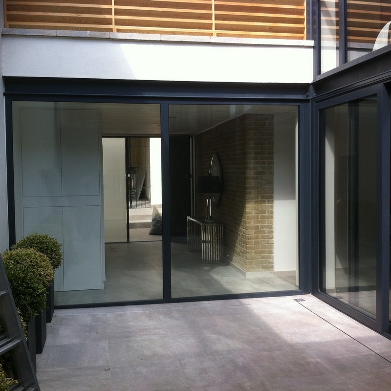 Floor-to-ceiling sliding doors opening to courtyard in South Norwood