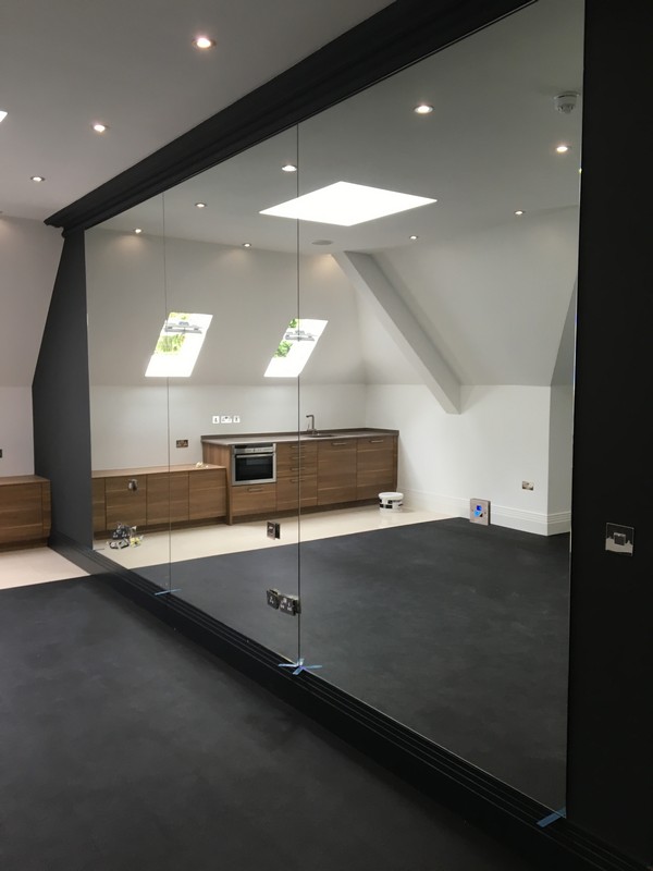 Frameless glass partition in loft conversion by South Norwood glaziers